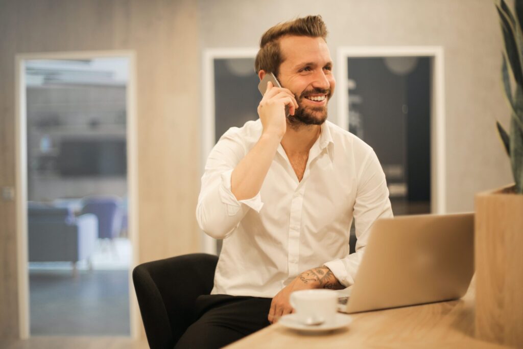 man drinking coffee on phone 