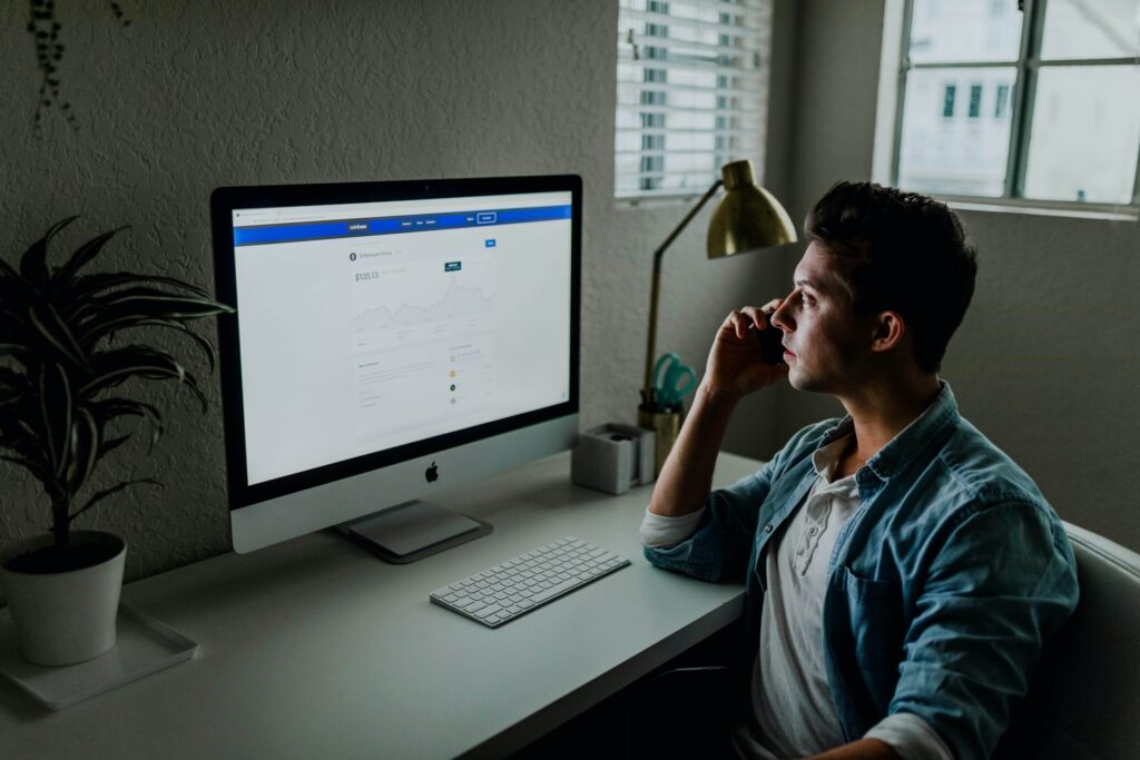 man at desk on phone 