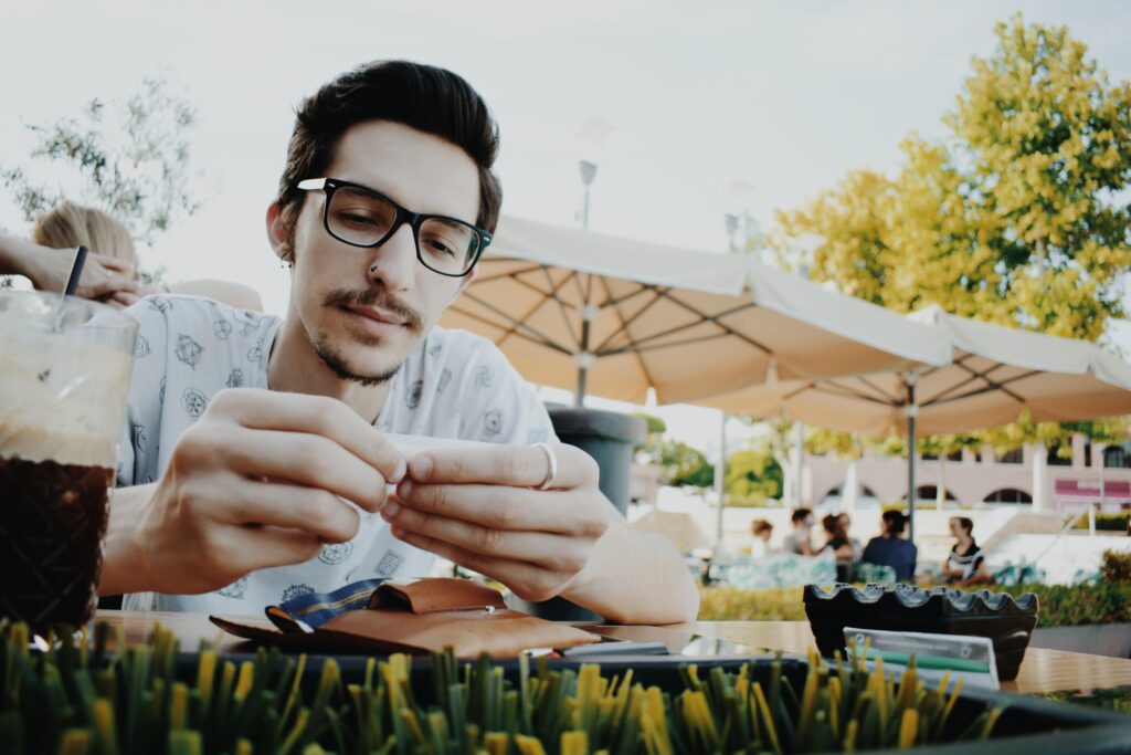 Man rolling tobacco with rolling papers