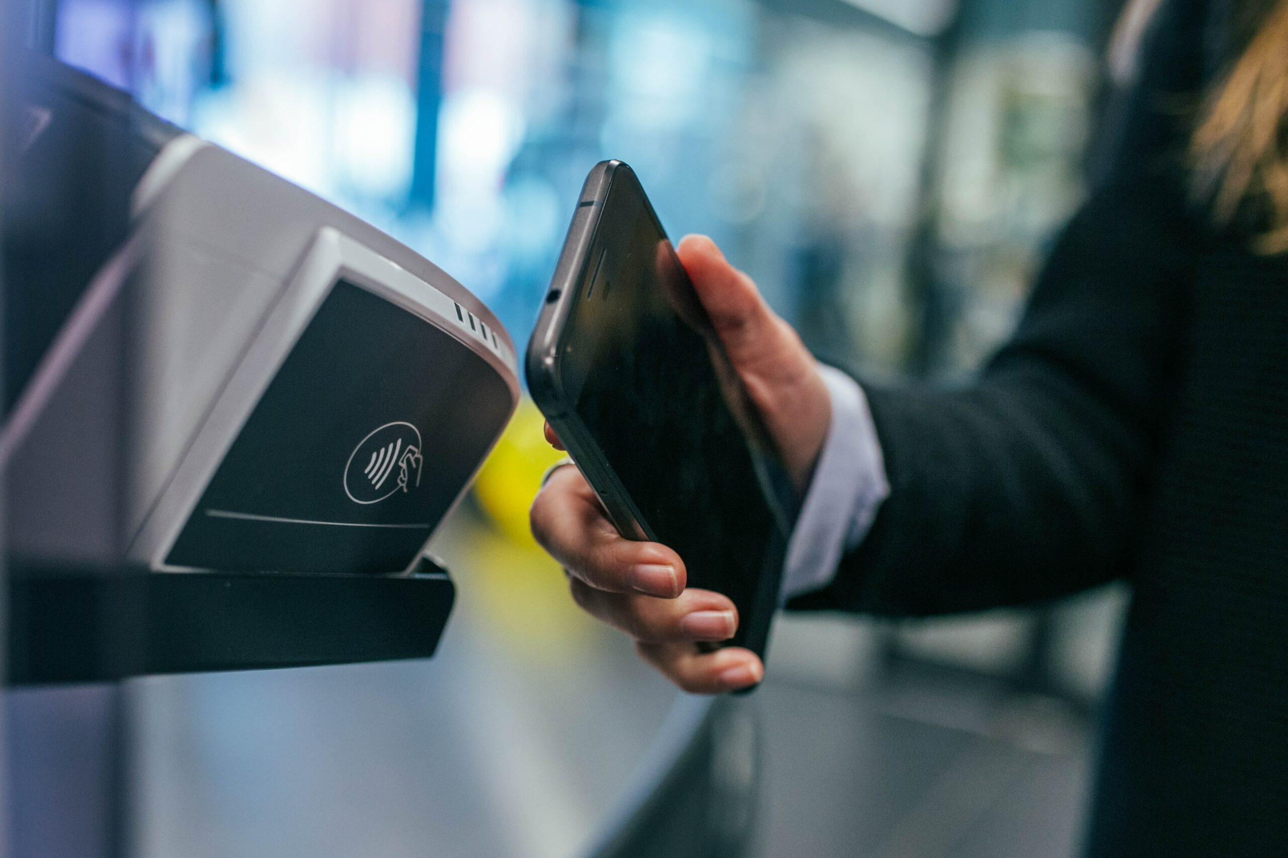 hand with iphone paying with nfc