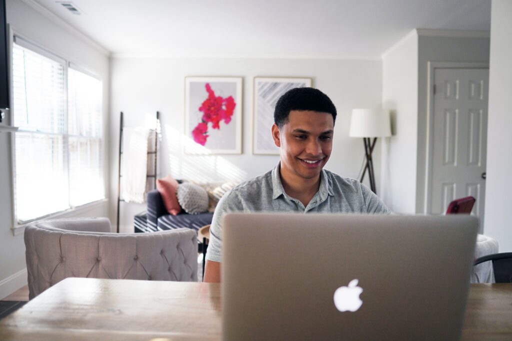 person at laptop in living room 