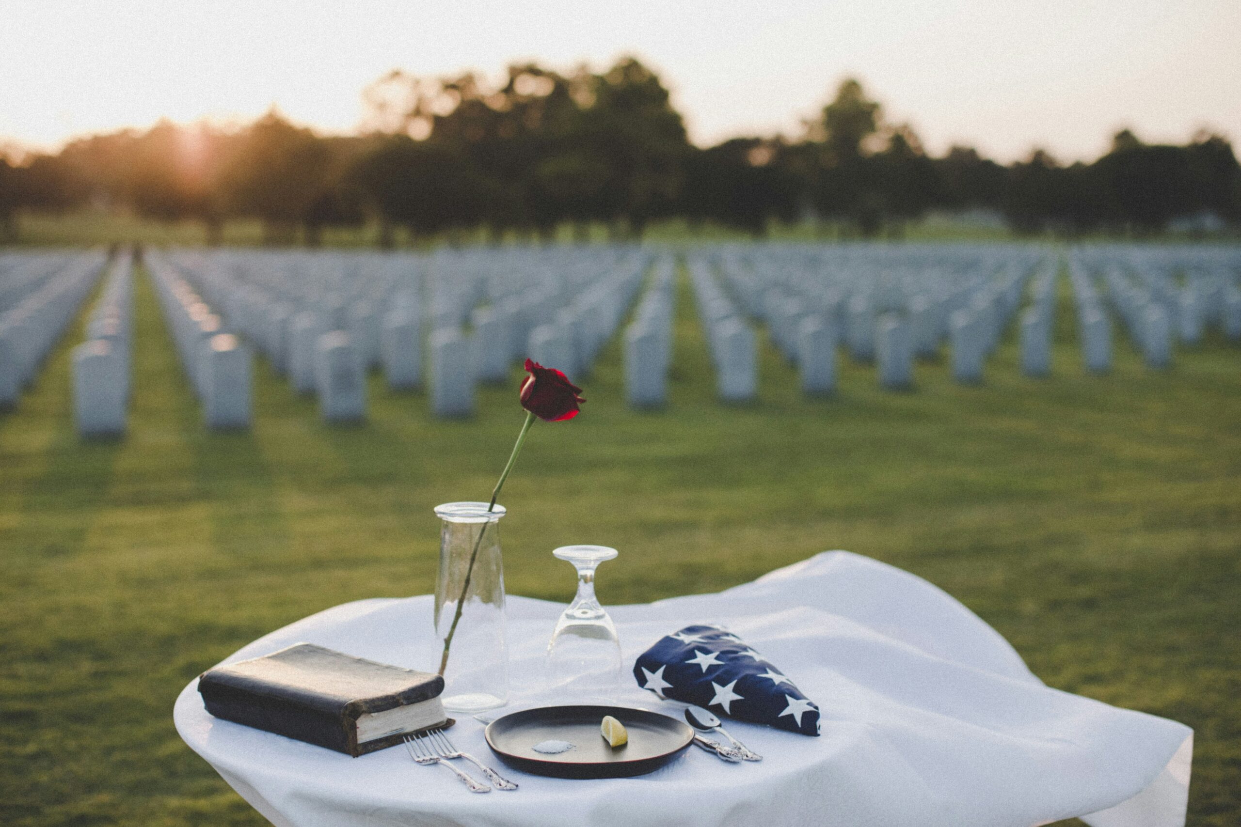 rose and flag at memorial site