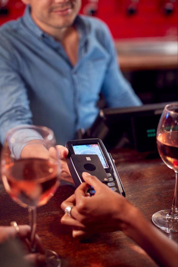 liquor-store-credit-card-processing a person paying for a card