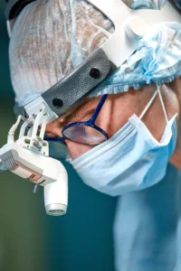 Female plastic surgeon in a surgical mask, representing the search for the best payment processor for a plastic surgery practice